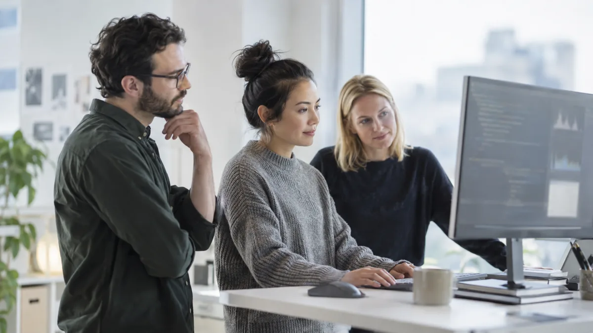A data team gathers at one screen to review a shared analysis notebook
